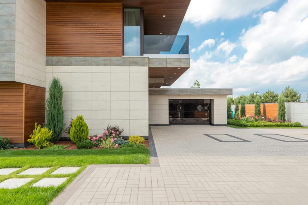 A modern minimalist house with a spacious concrete driveway in Houston.